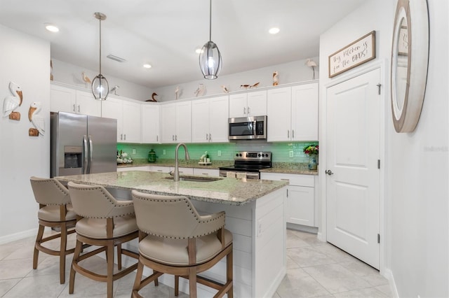 kitchen featuring appliances with stainless steel finishes, sink, and white cabinets