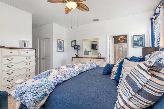 carpeted bedroom with ceiling fan and connected bathroom