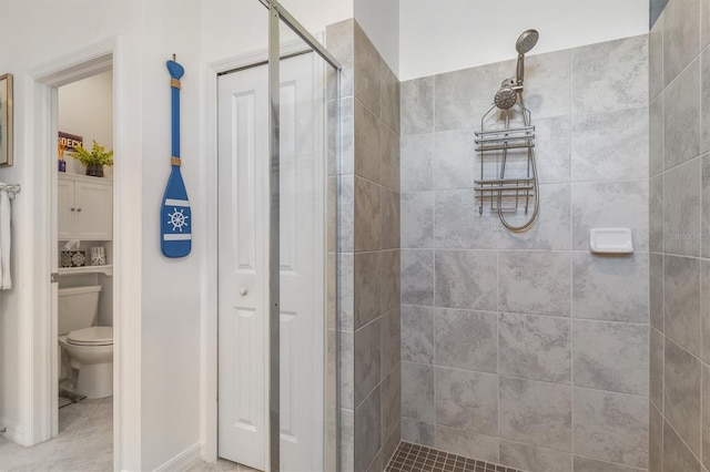 bathroom with toilet, tile patterned flooring, and a shower with door