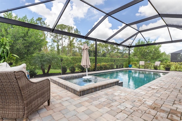 view of swimming pool featuring glass enclosure and a patio