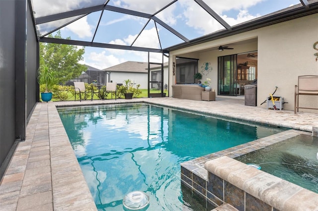 view of swimming pool featuring glass enclosure, a patio, and ceiling fan