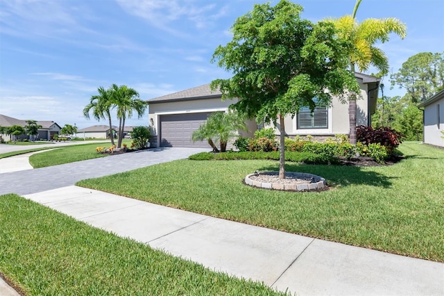 view of front of home with a front lawn and a garage