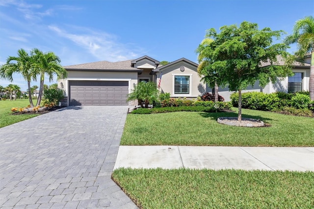 ranch-style house featuring a garage and a front lawn