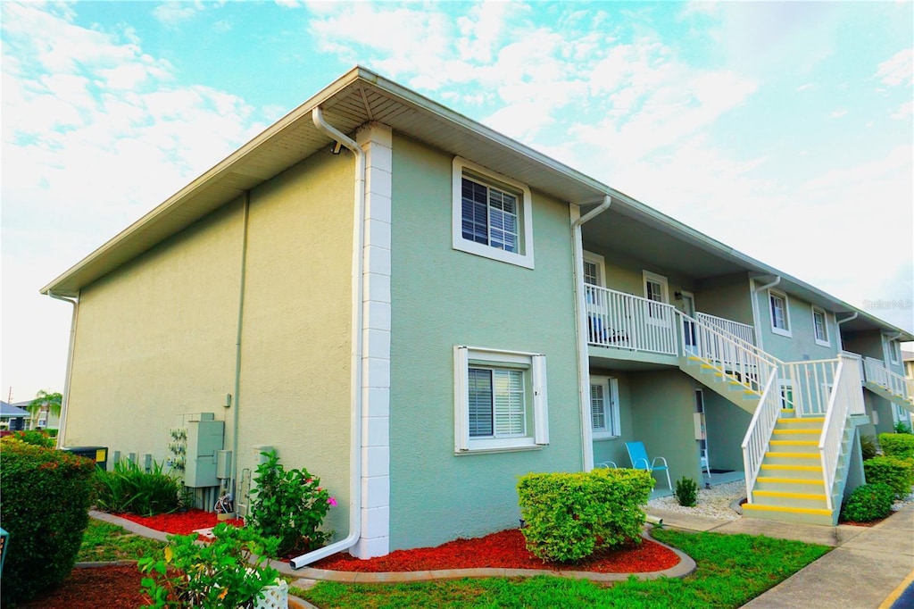 view of property exterior featuring stairway and stucco siding