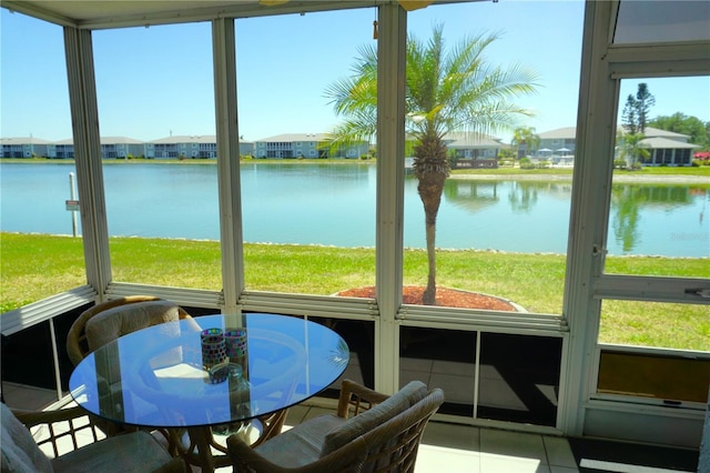 sunroom / solarium with a water view