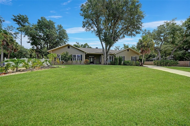 single story home with fence, a front lawn, and concrete driveway