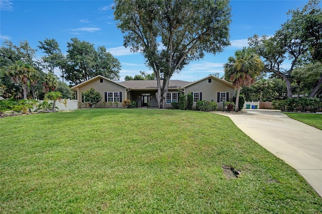 single story home with driveway and a front yard