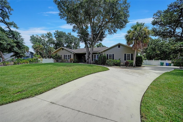 single story home featuring driveway, a front lawn, and fence