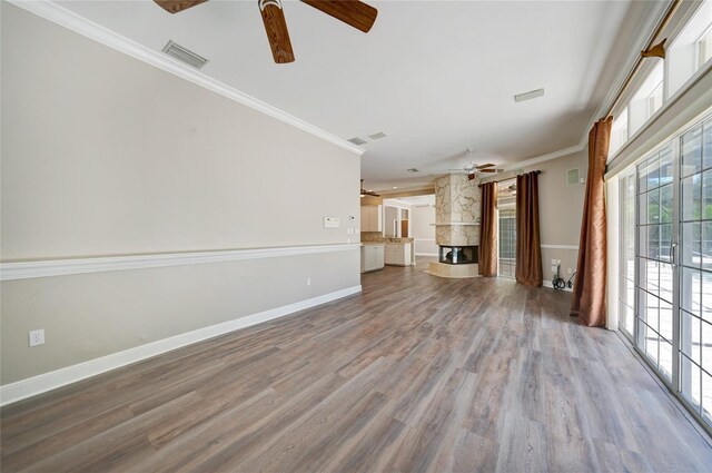 unfurnished living room with ceiling fan, french doors, crown molding, and hardwood / wood-style floors