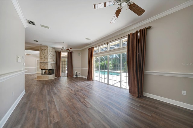 unfurnished living room with visible vents, dark wood-style flooring, crown molding, and a multi sided fireplace