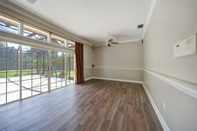 empty room featuring hardwood / wood-style floors, a wealth of natural light, and crown molding