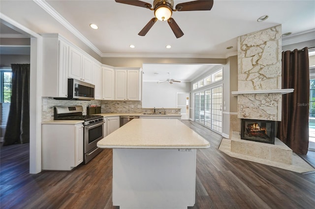 kitchen featuring white cabinets, a healthy amount of sunlight, stainless steel appliances, and light countertops