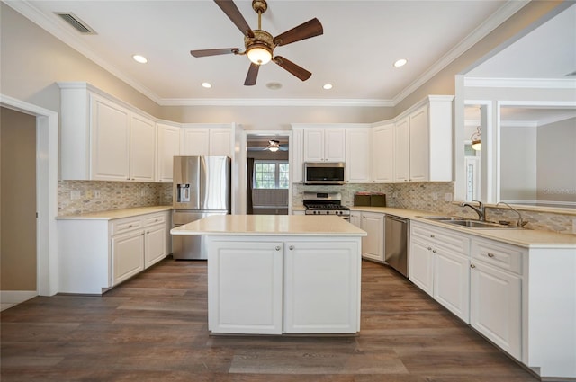 kitchen featuring stainless steel appliances, a sink, light countertops, and white cabinetry