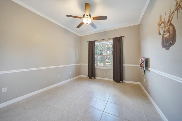 tiled empty room featuring ceiling fan and crown molding