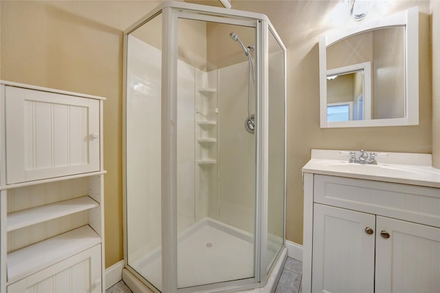 full bathroom with a shower stall and vanity