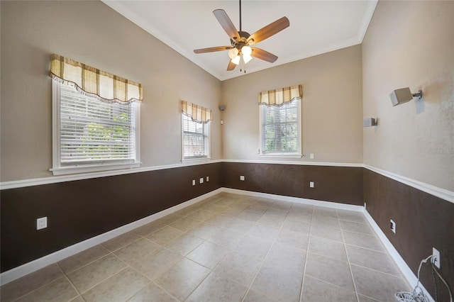 empty room with lofted ceiling, light tile patterned flooring, a ceiling fan, and crown molding