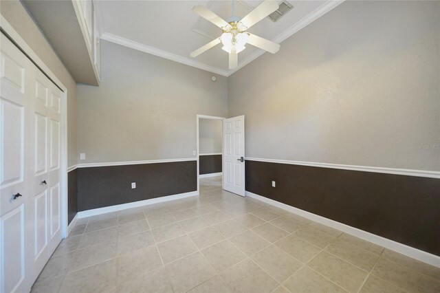 tiled spare room with high vaulted ceiling, ceiling fan, and crown molding