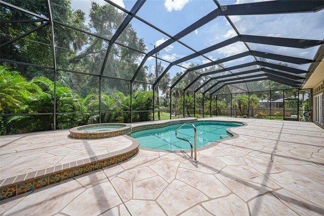 view of swimming pool with a patio area, a lanai, and an in ground hot tub