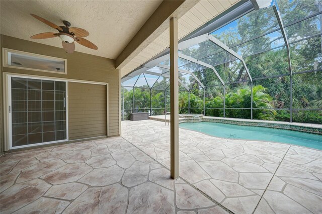 view of swimming pool with ceiling fan, a patio area, and a lanai