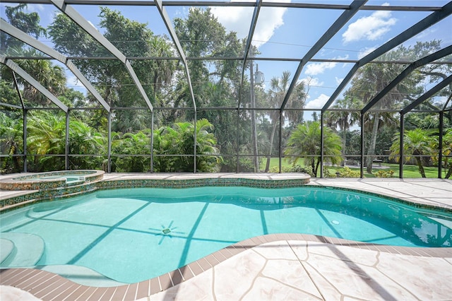 view of pool featuring glass enclosure, a patio, and a pool with connected hot tub