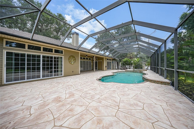 view of swimming pool featuring a patio area and a lanai