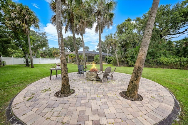 view of patio with an outdoor fire pit and fence