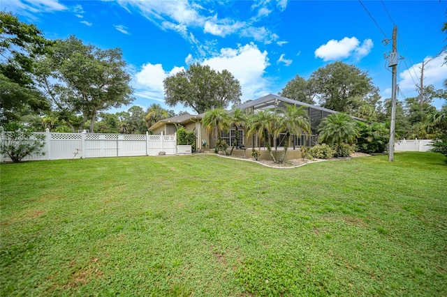 view of yard featuring a lanai and a fenced backyard