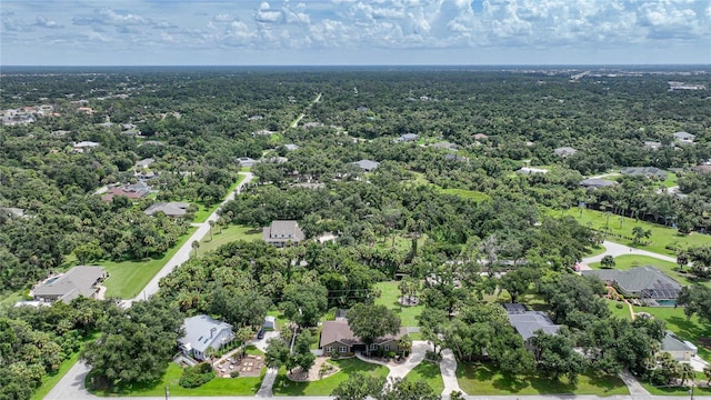 bird's eye view featuring a wooded view and a residential view