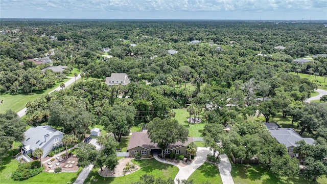 drone / aerial view with a wooded view and a residential view