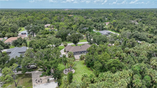 birds eye view of property featuring a wooded view and a residential view