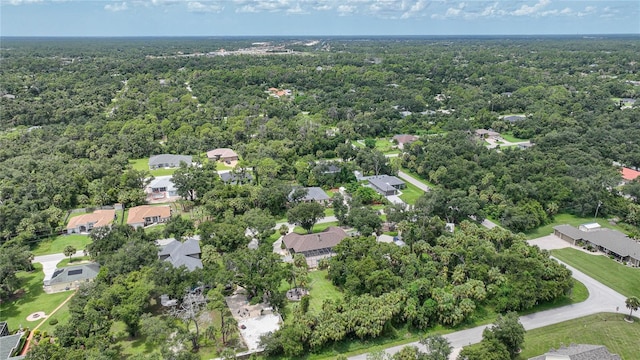 drone / aerial view featuring a forest view and a residential view