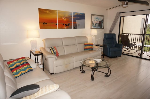 living room featuring ceiling fan and light wood-type flooring