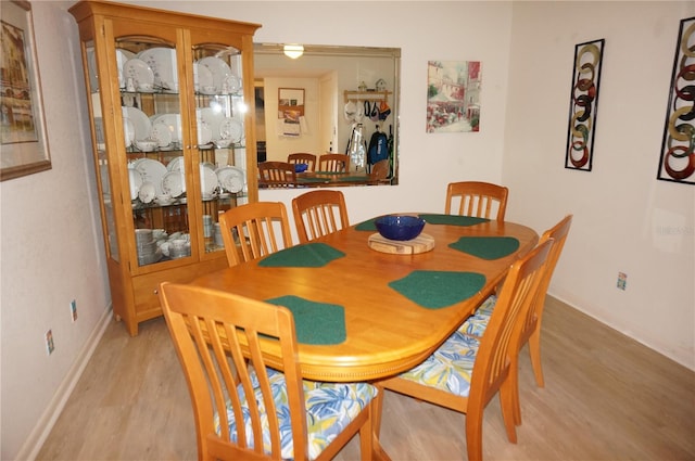 dining space with light hardwood / wood-style flooring