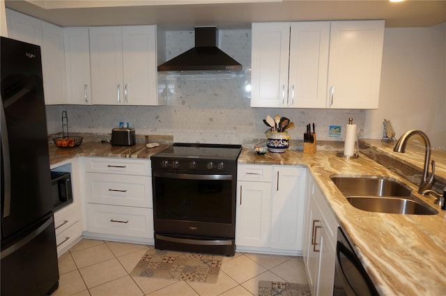 kitchen featuring wall chimney exhaust hood, black appliances, light tile patterned floors, sink, and white cabinetry