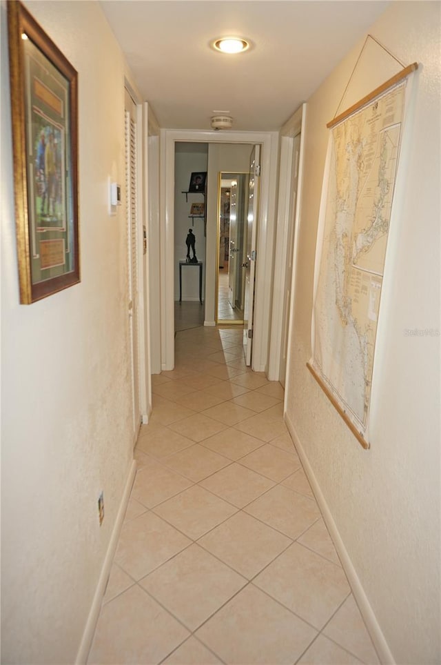 hall featuring light tile patterned flooring