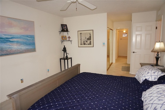 tiled bedroom featuring ceiling fan and a closet