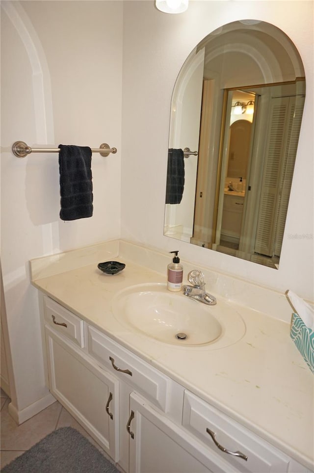 bathroom with tile patterned flooring and vanity