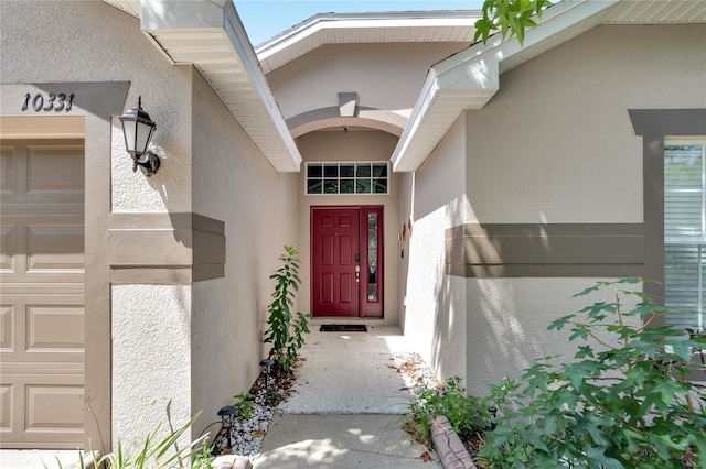 view of exterior entry with a garage