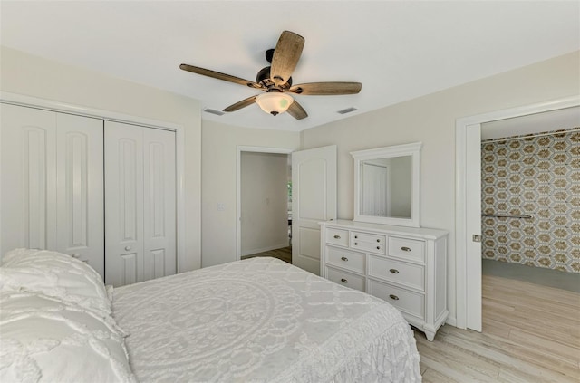 bedroom featuring light wood-style flooring, visible vents, a ceiling fan, and a closet