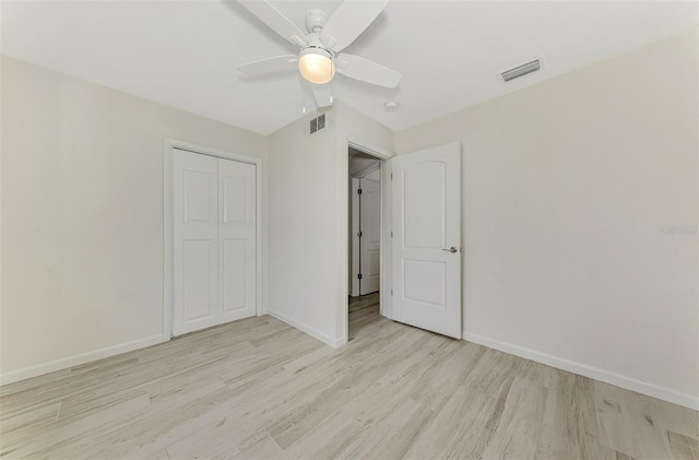 unfurnished bedroom featuring light wood-type flooring, visible vents, and baseboards