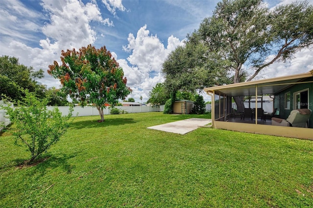 view of yard featuring a sunroom, a fenced backyard, and a patio area