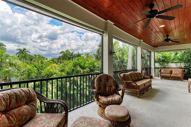 sunroom featuring ceiling fan and wooden ceiling