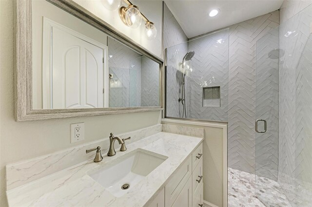 bathroom with a stall shower and vanity