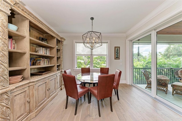 dining space with light wood-type flooring, ornamental molding, and a chandelier