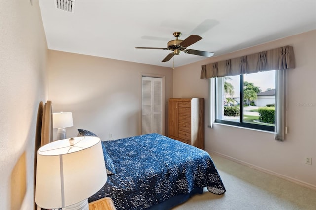 bedroom featuring ceiling fan, a closet, and carpet flooring