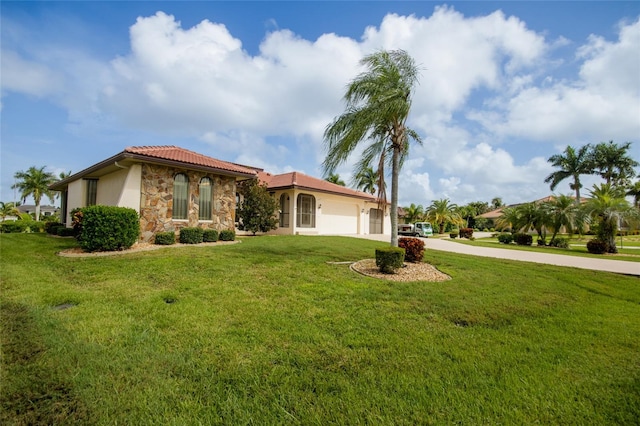 view of front of home featuring a front lawn and a garage