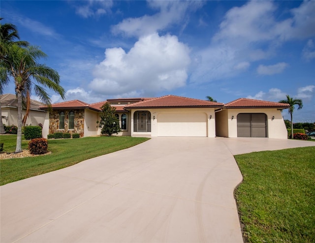 mediterranean / spanish house with a front yard and a garage