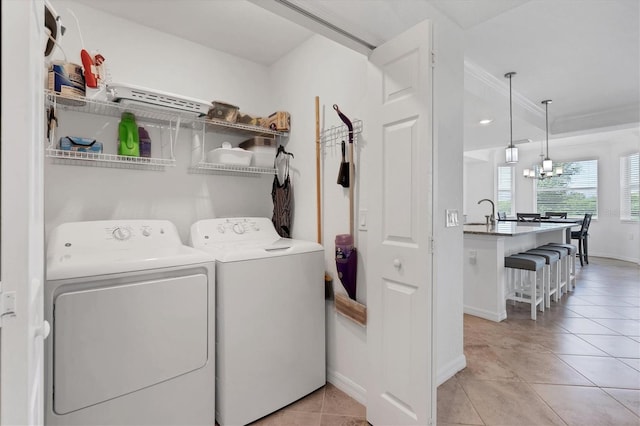 laundry area featuring independent washer and dryer, a chandelier, and light tile patterned flooring