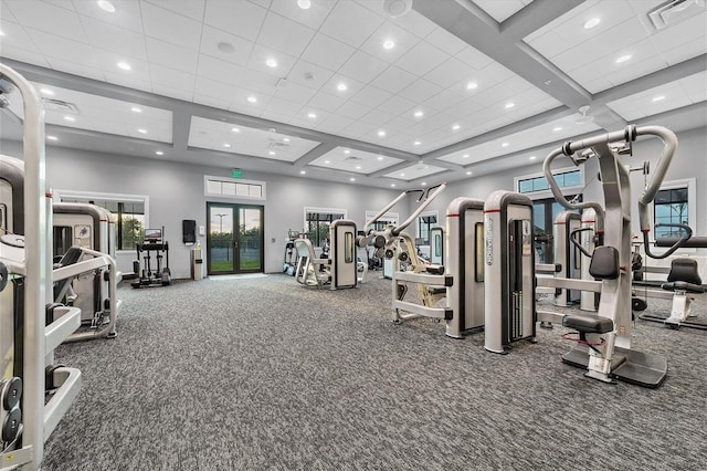 gym with carpet, a towering ceiling, coffered ceiling, and french doors