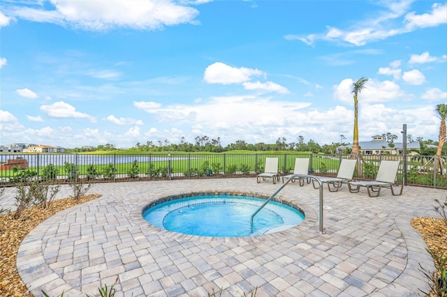 view of swimming pool with a patio area and a hot tub